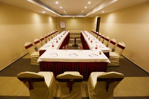 a conference room with a long table and chairs at Grand Serenaa Hotel & Resorts, Auroville in Auroville