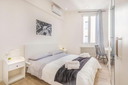 a white bedroom with a bed and a chair at Netflix&Chill - Yin & Yang Home in Modena