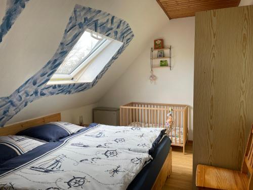 a bedroom with a bed and a window at Ostseebauernhof Schönhagen in Brodersby