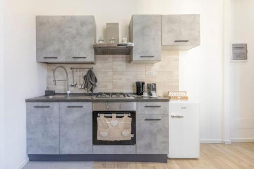 a kitchen with a sink and a stove top oven at Netflix&Chill - Yin & Yang Home in Modena