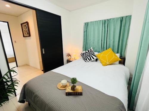 a bedroom with a bed with a tray on it at Relax House in Tokyo