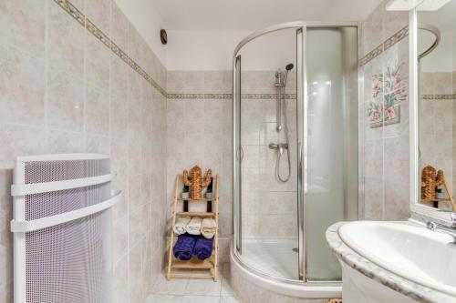 une salle de bain avec une douche, une baignoire et un lavabo dans l'établissement Le Bellevue à La Grande Pyramide, à La Grande Motte