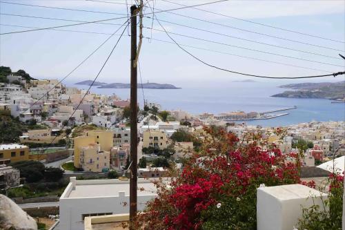 a view of a city with the ocean in the background at Artistic Cycladic House Ano Syros in Ermoupoli