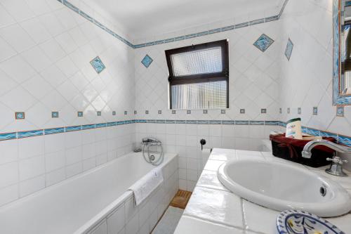 a white bathroom with a tub and a sink at Quinta das Achadas - Jasmine in Lagos