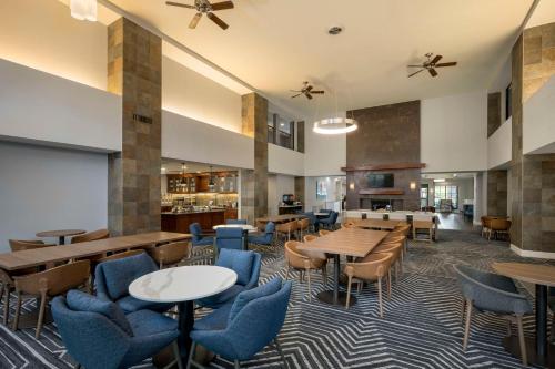 a lobby with tables and chairs and a cafeteria at Homewood Suites by Hilton Phoenix North-Happy Valley in Phoenix