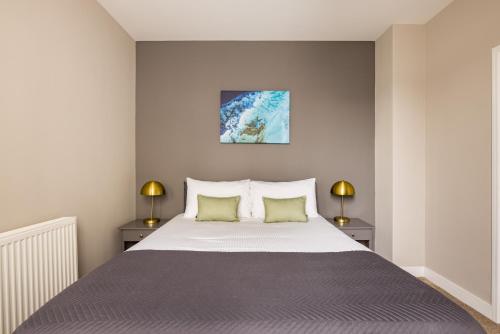 a bedroom with a large bed with two lamps at Charles Hope Plymouth in Plymouth