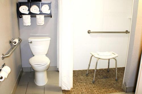 a bathroom with a toilet and a stool at Quality Inn & Suites Bedford West in Bedford
