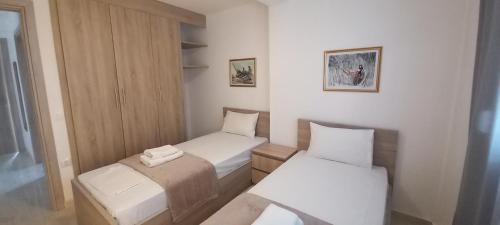 a small room with two beds and a window at Verano house in Néa Tríglia