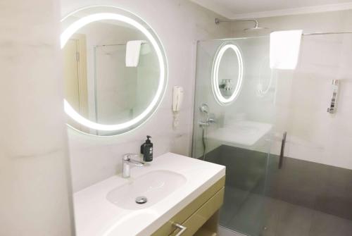 a white bathroom with a sink and a mirror at La Quinta by Wyndham Giresun in Giresun
