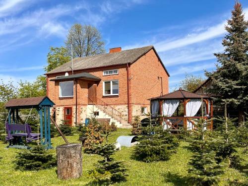 a brick house with a gazebo in the yard at Sielski Dom (dotrzesz bez auta!) 