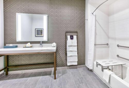 a bathroom with a sink and a shower at La Quinta Inn & Suites by Wyndham Terrell in Terrell