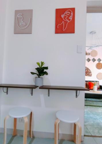 a shelf on a wall with two stools at HOST HOMES-SANDY LANE in Tacloban