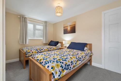a bedroom with two beds and a window at Kemendine Harbour View in Tenby