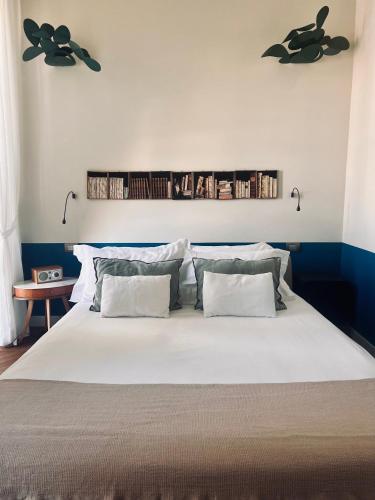 a bedroom with a large white bed with two pillows at Accademia 39 in Sorrento