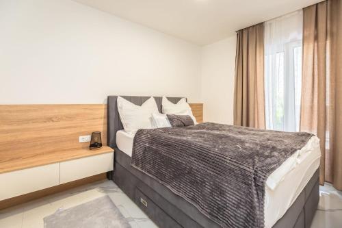 a bedroom with a large bed and a window at Delux apartments Selina in Baška Voda