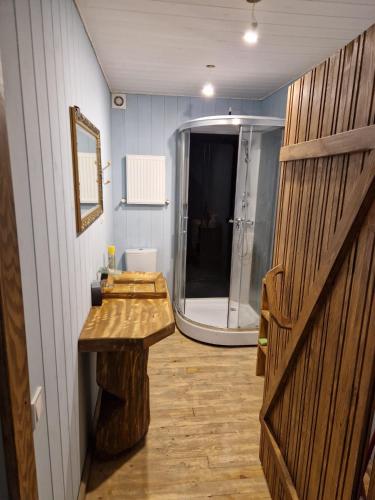 a bathroom with a sink and a shower in it at Bajāri - Viesu Māja in Svente