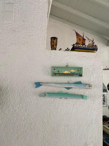 three pairs of scissors hanging on a wall at Alexandra villas in Gouvia