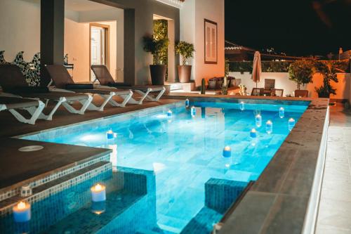a swimming pool with candles in the middle of it at Villa in south of Tenerife in Arona