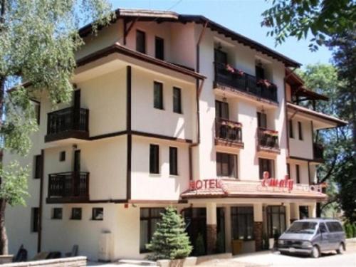 a building with a car parked in front of it at Family Hotel Emaly 2 in Sapareva Banya