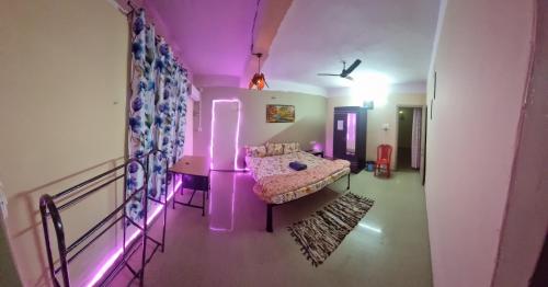 - un salon avec un éclairage violet et un canapé dans l'établissement Elegance Delight- Entire 2BHK spacious Flat, à Guwahati