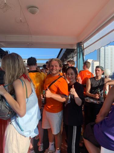 a group of people wearing life jackets standing in a boat at Saigon Rooftops Hostel in Ho Chi Minh City