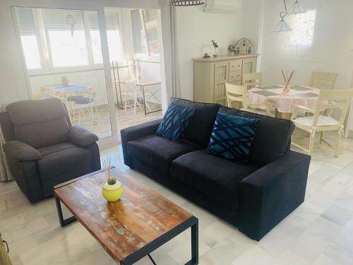 a living room with a couch and a table at Mar azul in Torrox Costa