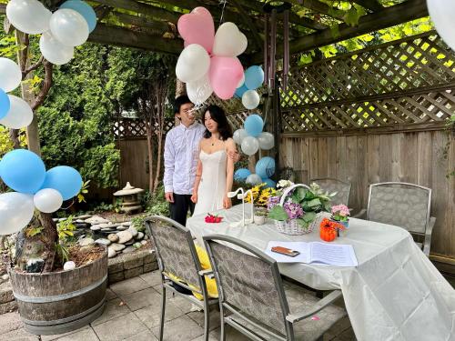 a bride and groom standing next to a table with balloons at Scorpion Hiuse Langley ROOM B in Langley