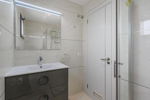 a white bathroom with a sink and a shower at Casa independiente con piscina privada in Adeje