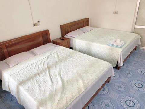 two beds in a small room withthritisthritis at Friendly room in Hai Phong