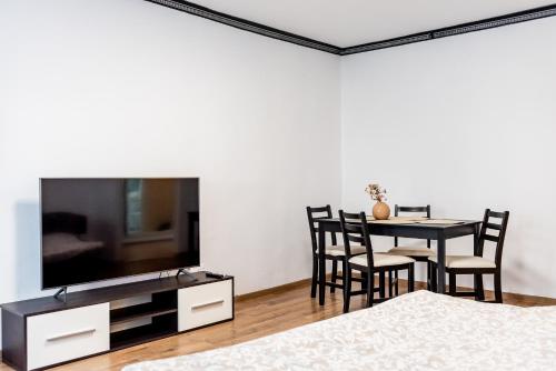 a living room with a dining table and a tv at Lady-s in Cluj-Napoca