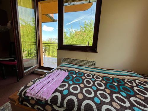 a bedroom with a bed with a view of a window at Villas by Expert Vrelo Bosne in Vruci