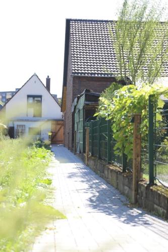 an alley in a house with a fence at Appartment 25 - Hotel Weilerhof in Dormagen