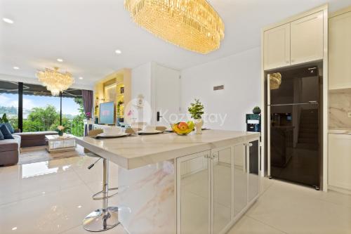 a kitchen with a large white island in a room at Lumiere by Kozystay - Dago in Bandung