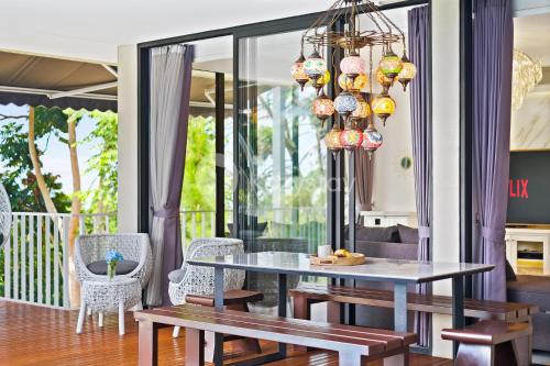 a dining room with a table and chairs at Lumiere by Kozystay - Dago in Bandung