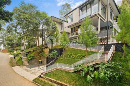 an exterior view of a house with a garden at Lumiere by Kozystay - Dago in Bandung