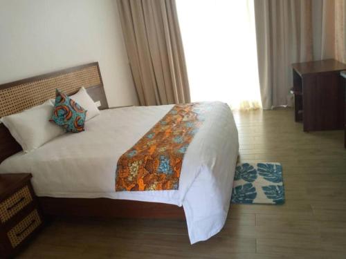 a bedroom with a large bed in a room at Eben Lake Kivu cottages and Villas in Kagano