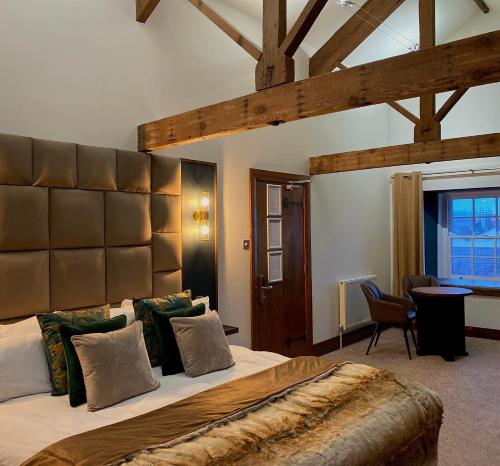 a bedroom with a large bed with a large headboard at The Cawdor in Llandeilo