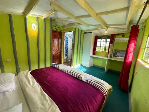 a bed in a room with green walls at Tree house in Ngong