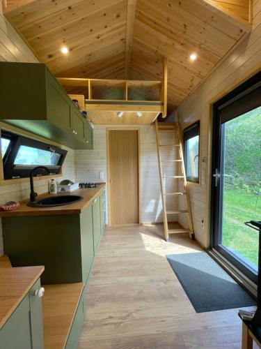 a kitchen in a tiny house with a large window at Tiny Home in Dejani