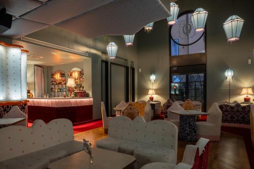 a restaurant with white chairs and tables and a mirror at Hotel Number Nine in Florence
