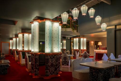 a restaurant with white chairs and tables and lights at Hotel Number Nine in Florence