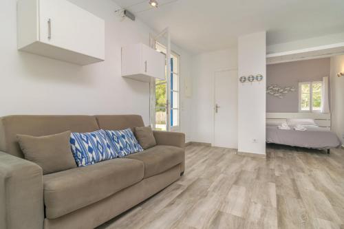 a living room with a couch and a bedroom at Sestanyol in Colonia de Sant Pere