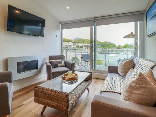 a living room filled with furniture and a large window at Sea Breeze in Porthmadog