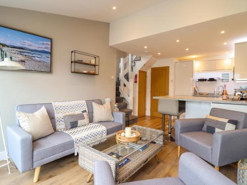 a living room with a couch and a table at Sea Breeze in Porthmadog