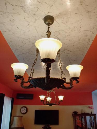 a chandelier hanging from a ceiling in a room at Marilyn Apartments in Smederevo