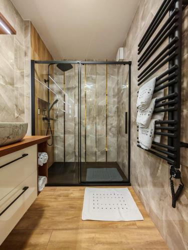 a shower with a glass door in a bathroom at AquaSuite Budapest in Budapest