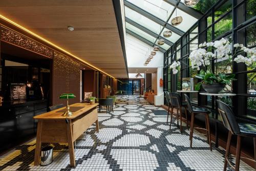 a lobby with a table and chairs in a building at Novotel Paris Les Halles in Paris