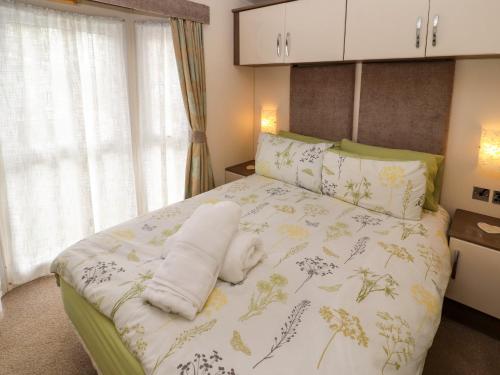 康福斯的住宿－Lakeside Haven，卧室配有一张带白色床单和枕头的大床。