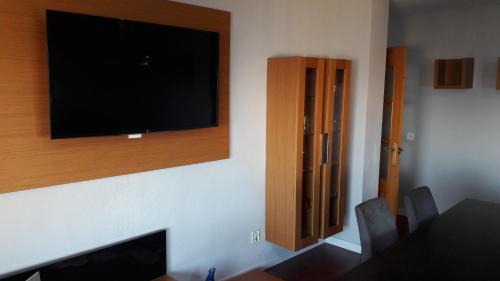 a living room with a flat screen tv on a wall at Fantástico apartamento en la playa san Juan in Alicante
