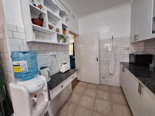a bathroom with a toilet in a kitchen at 6th Avenue Court in Nairobi